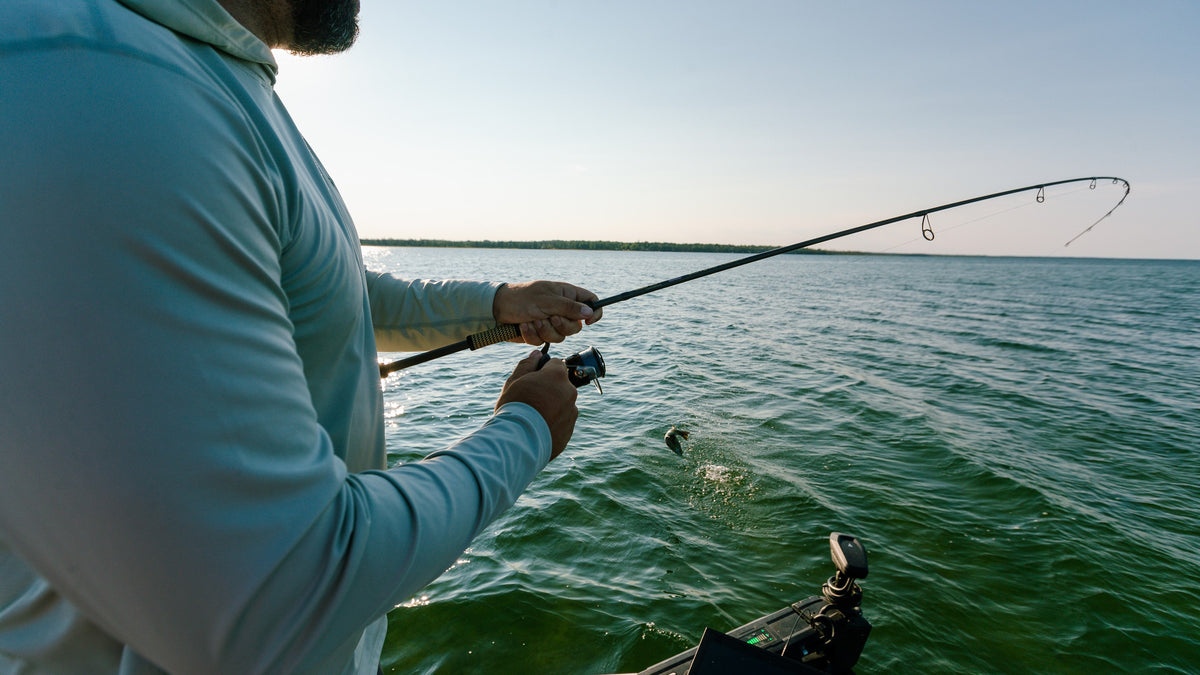 Angler fighting a bass on a Cashion Elite Pro rod