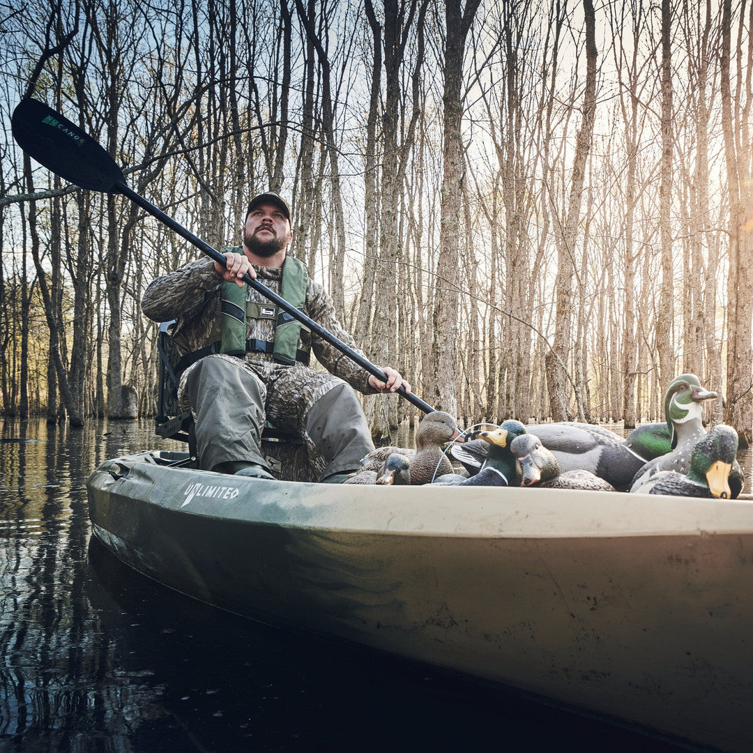Hunter paddling a NuCanoe kayak loaded with duck decoys